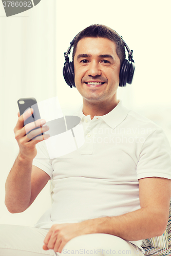 Image of happy man with smartphone and headphones