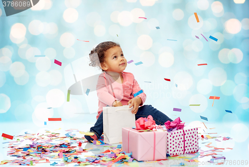 Image of happy little baby girl with birthday presents