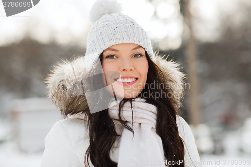 Image of happy woman outdoors in winter clothes