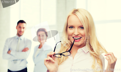 Image of smiling businesswoman or secretary in office