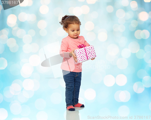 Image of beautiful little baby girl with birthday present