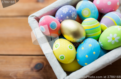 Image of close up of colored easter eggs in basket