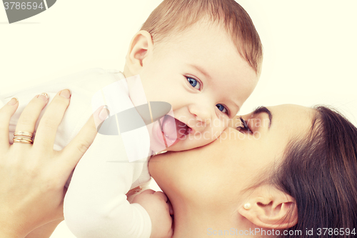 Image of happy mother kissing baby