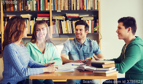 Image of students with books preparing to exam in library