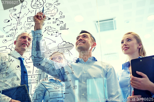 Image of smiling business people with marker and stickers