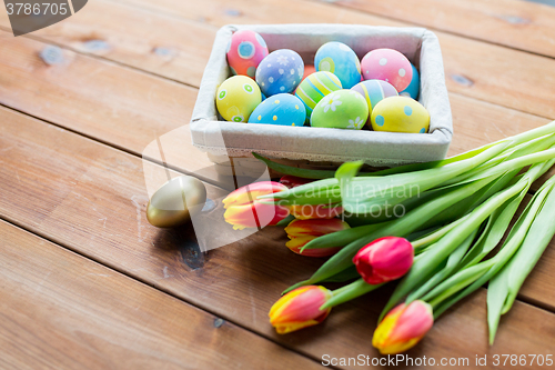 Image of close up of colored easter eggs and flowers