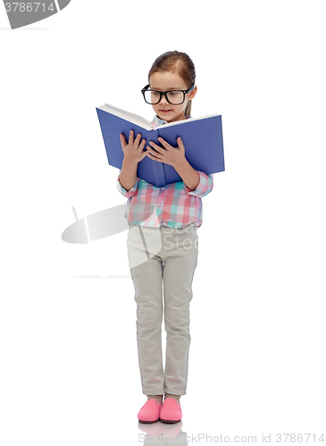 Image of happy little girl in eyeglasses reading book