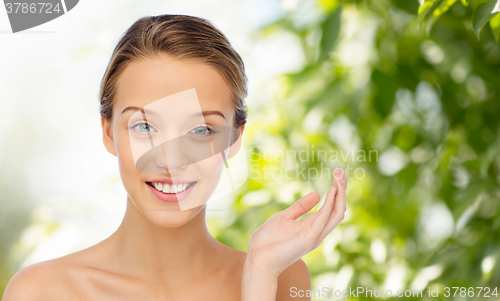 Image of smiling young woman face and shoulders