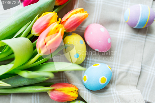 Image of close up of colored easter eggs and flowers