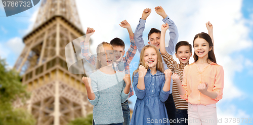 Image of happy kids celebrating victory over eiffel tower