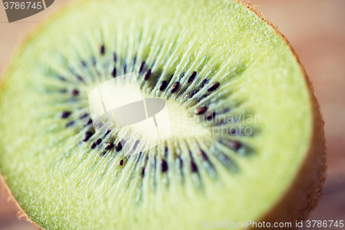 Image of close up of ripe kiwi slice on table