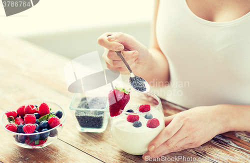 Image of close up of woman hands with yogurt and berries