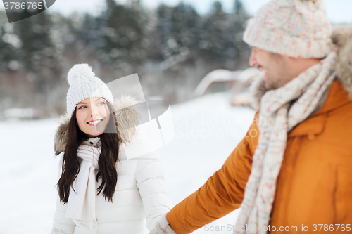 Image of happy couple walking over winter background