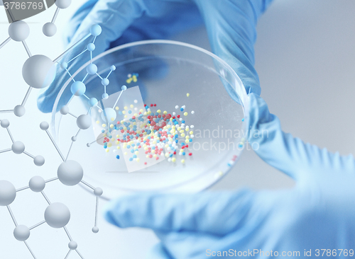 Image of close up of scientist hands holding chemical cure