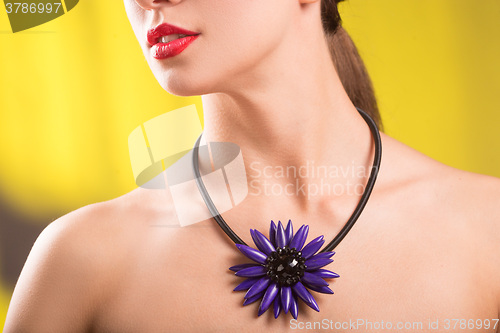 Image of Lifestyle fashion portrait of stylish  young woman in trendy sunglasses ,bright  necklace . Summer bright colors.
