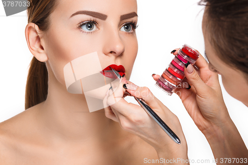 Image of Beautiful female lips with make-up and brush