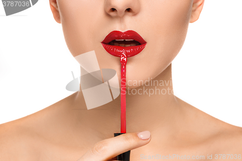 Image of Beautiful female lips with make-up and brush