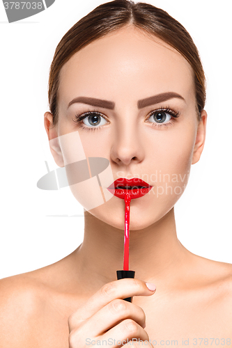 Image of Beautiful female lips with make-up and brush