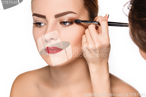 Image of Beautiful female eyes with make-up and brush