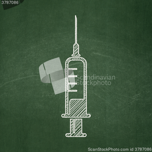 Image of Health concept: Syringe on chalkboard background
