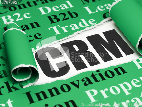 Image of Business concept: black text CRM under the piece of  torn paper