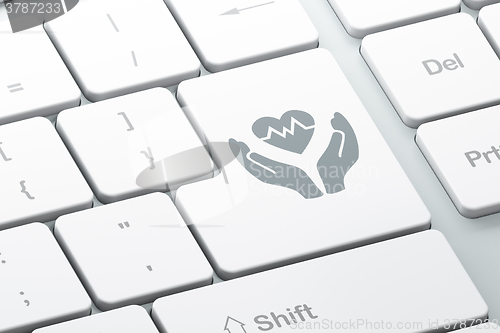 Image of Insurance concept: Heart And Palm on computer keyboard background