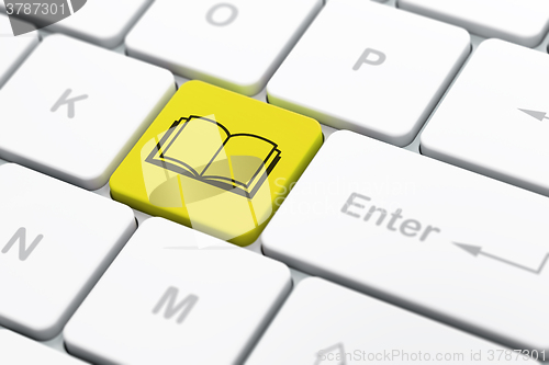 Image of Science concept: Book on computer keyboard background