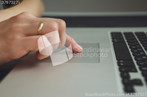 Image of woman\'s hands working on laptop computer