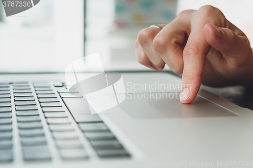 Image of woman\'s hands working on laptop computer