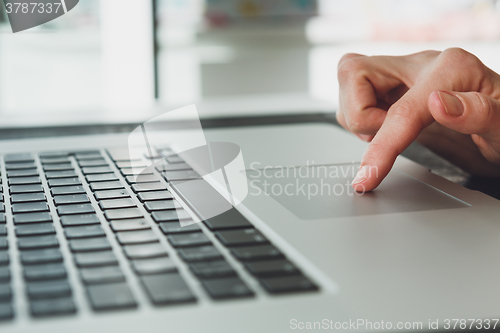 Image of woman\'s hands working on laptop computer