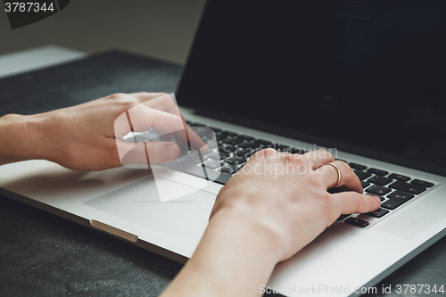 Image of woman\'s hands working on laptop computer