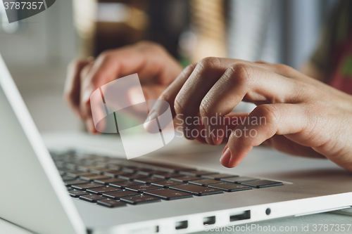 Image of woman\'s hands working on laptop computer