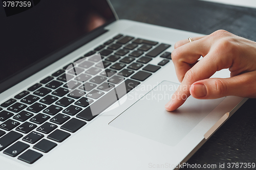 Image of woman\'s hands working on laptop computer