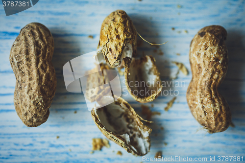 Image of Fresh peanuts in shell on blue desk
