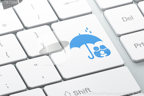 Image of Safety concept: Family And Umbrella on computer keyboard background