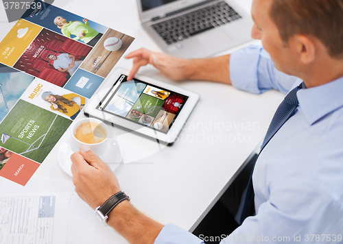 Image of businessman with tablet pc and coffee in office