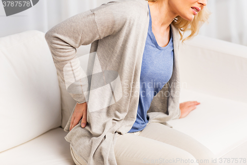 Image of close up of woman suffering from backache at home