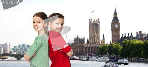 Image of happy boy and girl standing together over london