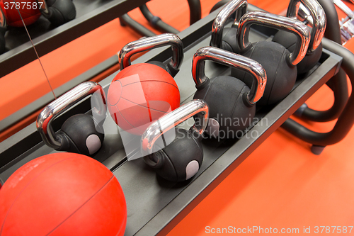 Image of close up of kettlebells and medicine ball in gym