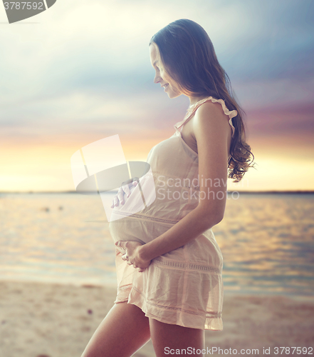 Image of happy pregnant woman in chemise