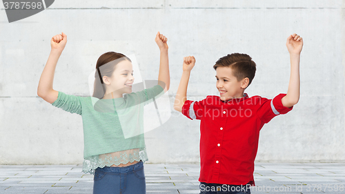 Image of happy boy and girl celebrating victory