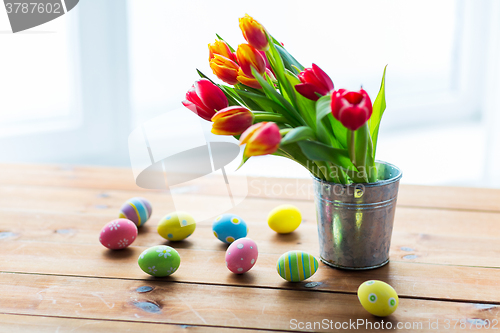 Image of close up of easter eggs and flowers in bucket