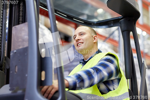 Image of man operating forklift loader at warehouse