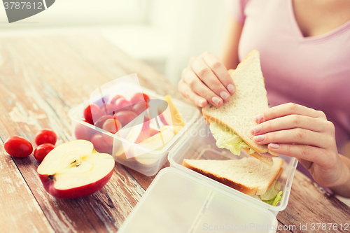 Image of close up of woman with food in plastic container