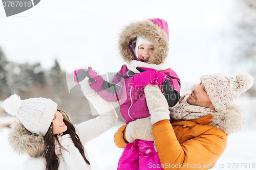 Image of happy family with child in winter clothes outdoors