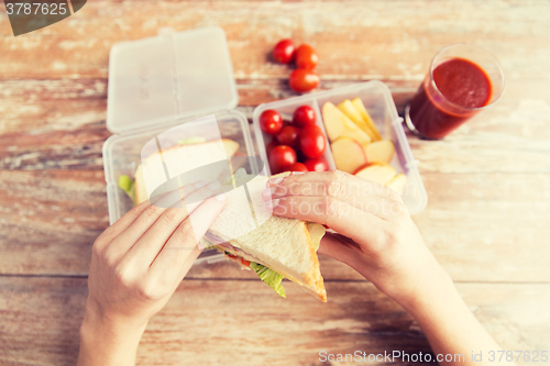 Image of close up of woman with food in plastic container