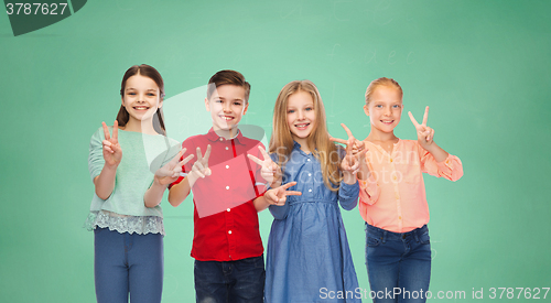 Image of happy boy and girls showing peace hand sign