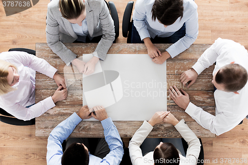 Image of close up of business team sitting at table