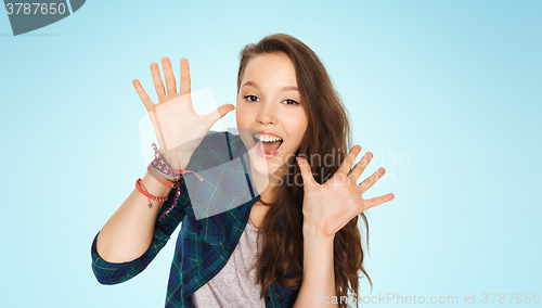 Image of happy laughing pretty teenage girl showing hands