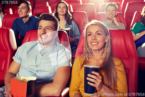 Image of happy friends watching movie in theater